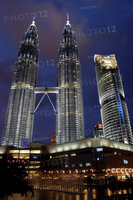 MALAYSIA, Kuala Lumpur, Angled view looking up at the Petronas Twin Towers illuminated at night