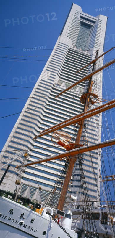 JAPAN, Honshu, Yokohama, View of the Nippon Maru tall ships mast with Landmark Tower skyscraper behind