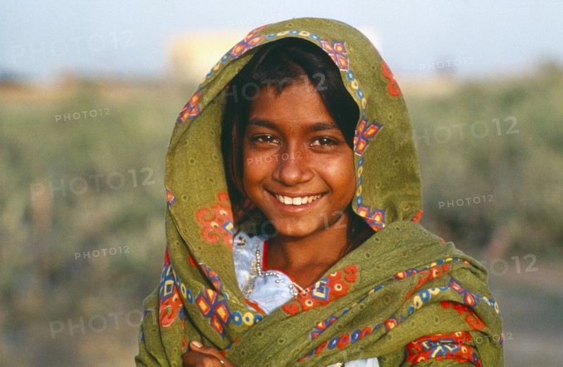 PAKISTAN, Sindh Province, Portrait of smiling Gypsy girl.