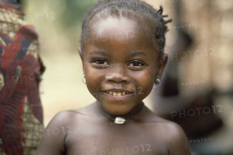 SIERRA LEONE, People, Children, Head and shoulders portrait of young Mende girl smiling .