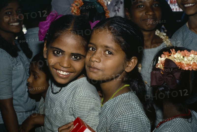 INDIA, Tamil Nadu, "Portrait of two school girls, others behind."