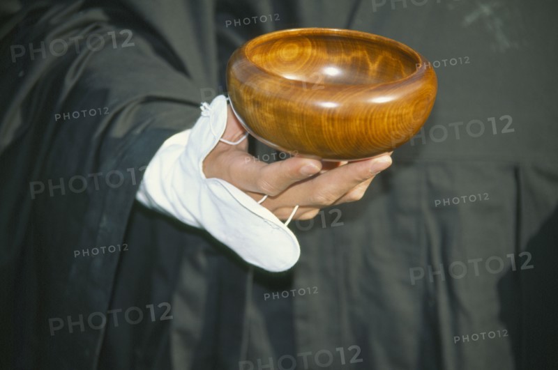 JAPAN, Obama, Cropped view of Zen Buddhist monk holding bowl for collection of alms.