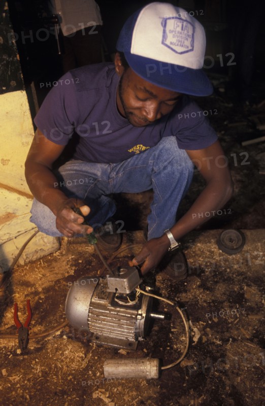 KENYA, Loitokitok, A mechanic repairs an electric motor