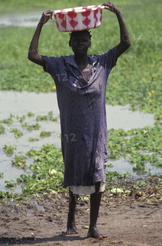 KENYA, , A woman collecting water from a lake source. Contaminated water sources are the leading cause of stomach illness in Africa.