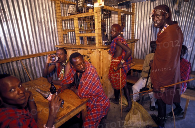 KENYA, Near Kajiado, Maasai Moran drinking in a bar. Alcoholism is a particular problem amongst the Maasai.