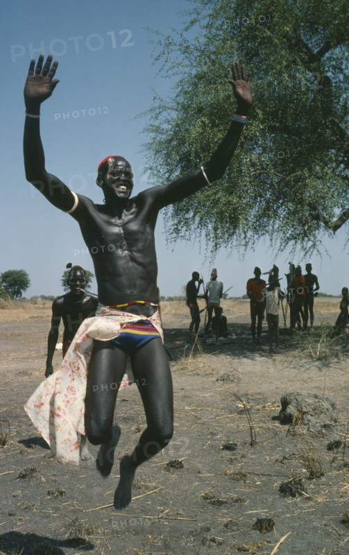 SUDAN, People, Dinka tribesman leaping into air.