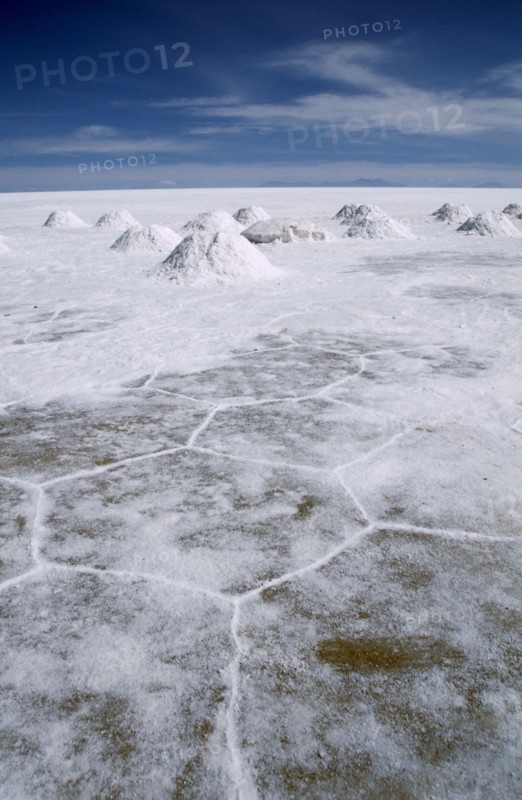 BOLIVIA, Uyuni, Salar de Uyuni, Salt flats with salt shovelled in to piles awaiting collection