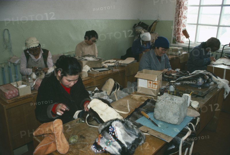 RUSSIA, Siberia, Kamchatka, Lesnoe.  Workers in factory making boots and hats from reindeer skin.