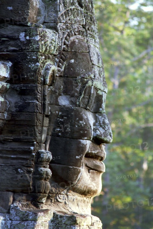 CAMBODIA, Angkor, The Bayon. One of the faces of the late twelth to early thirteenth century pyramid temple built in the centre of the ancient city of Angkor Thom