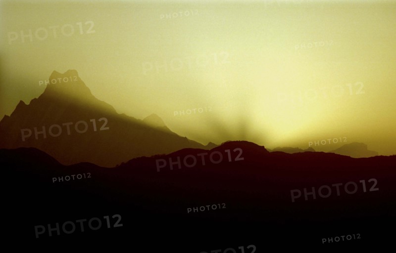 NEPAL, Annapurna Massif, Mountain range in silhouette at sunset viewed from Poon Hill