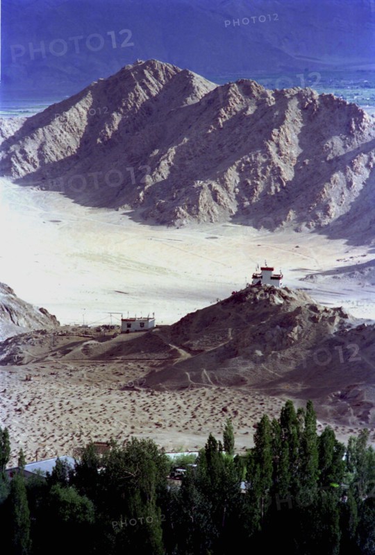 INDIA, Ladakh, Leh, View toward distant Temples on the outskirts of the town against a backdrop of mountains