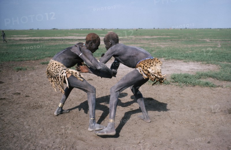 SUDAN, Tribal People, Dinka tribesmen wrestling.