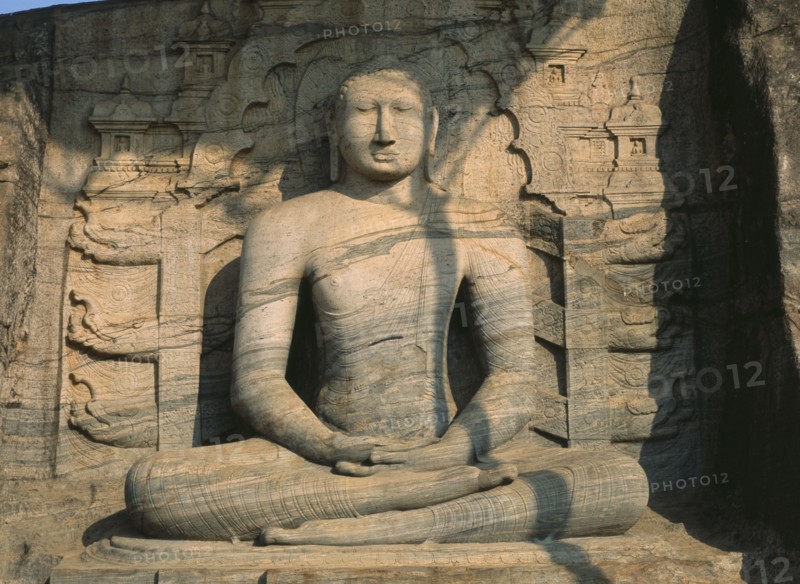 SRI LANKA, Polonnaruwa, Gal Vihara.  Mid twelth century seated Buddha figure carved from granite.
