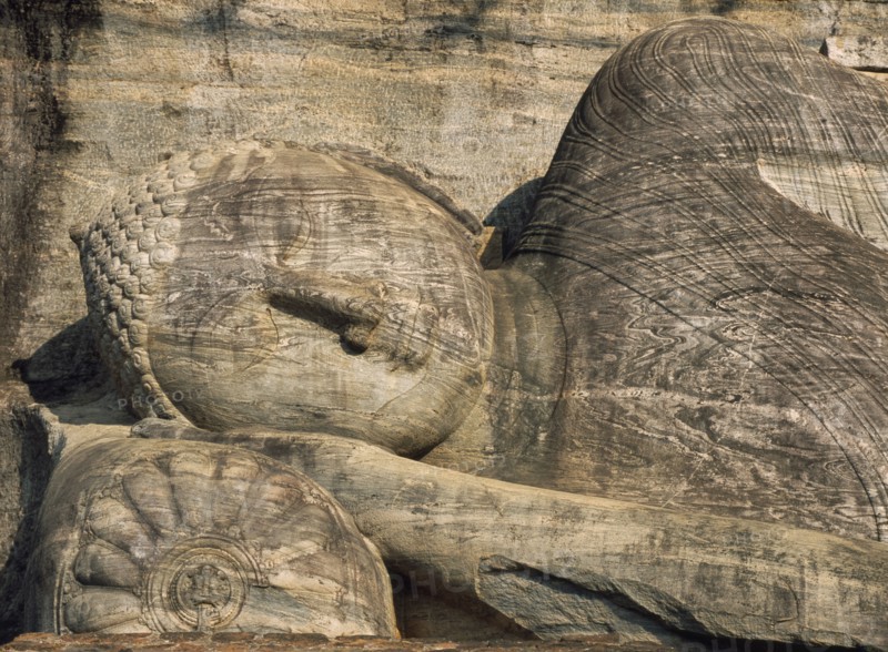 SRI LANKA, Polonnaruwa, Gal Vihara.  Mid twelth century reclining Buddha figure shown at the moment of entry into nirvana and carved from granite.  Detail of head and face.