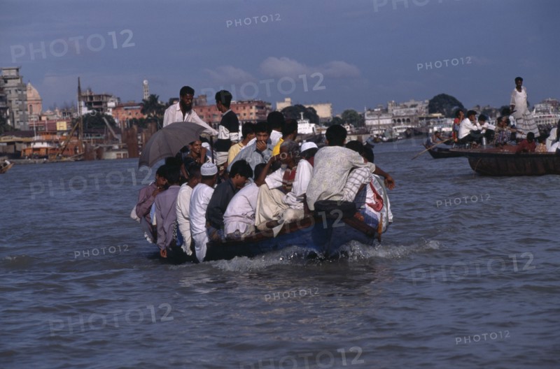 BANGLADESH, Dhaka, Overloaded country boat crossing the Buriganga River
