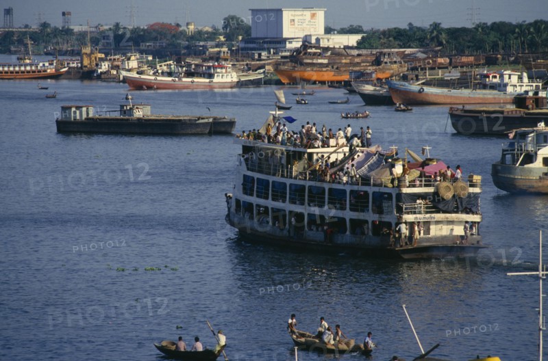 BANGLADESH, Dhaka, Crowded steamer leaving the Sadarghat terminal for the south.  People camped under makeshift tents on top deck.