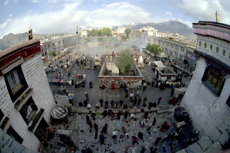 CHINA, Tibet, Lhasa, Wide angle view from the rooftop of the Jokhang Temple over people lying prostrate in front