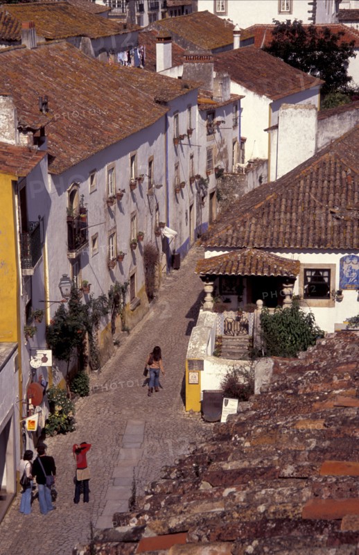 PORTUGAL, Leiria, Obidos, General view over cobbled street and rooftops