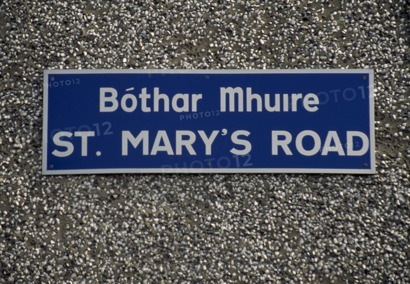 IRELAND, Donegal, Inishowen, Street name sign in Gaelic and English.