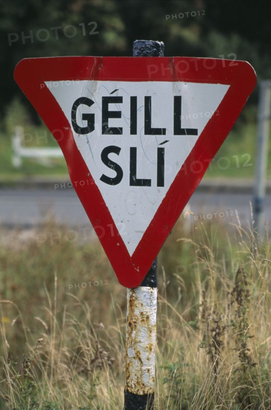 IRELAND, Donegal, Inishowen, Road sign in Gaelic.