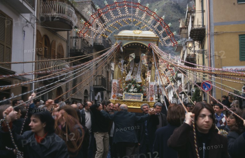 ITALY, Sicily, Easter procession with statue of a saint being carried through the street