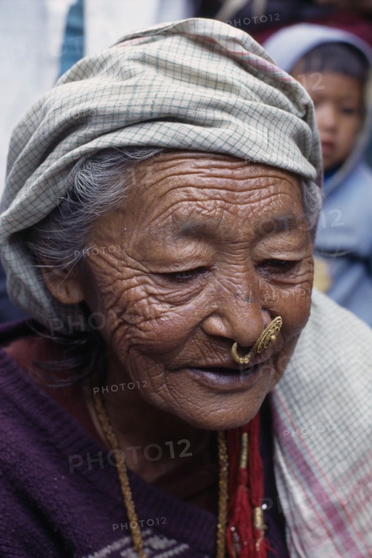 NEPAL, East, Dhankuta Region, Elderly Limbuni tribeswoman wearing traditional gold Limbu nose jewellery