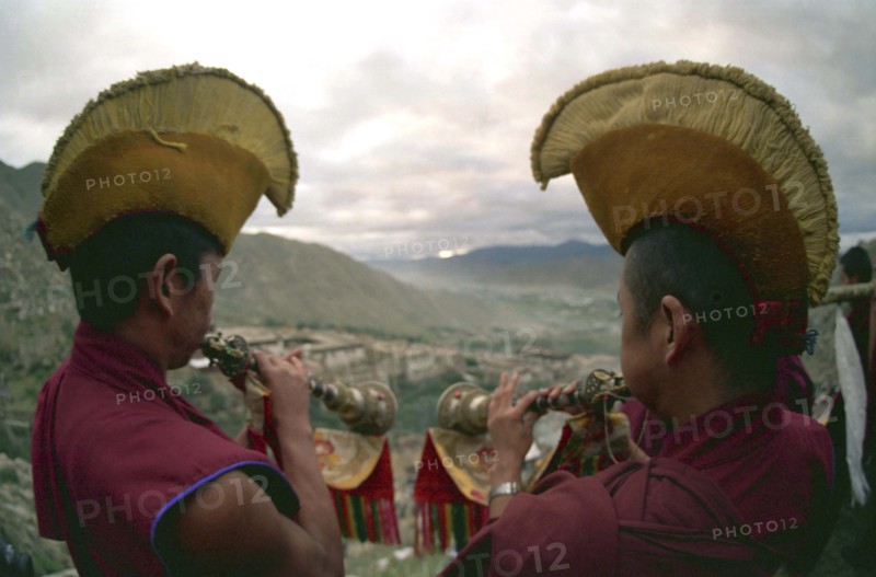 CHINA, Tibet, Drepung Monastery, Two monks blowing spiritual horns