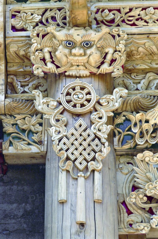 CHINA, Gansu, Xiahe, Detail of carved ornamental Guardians made to protect the Temple