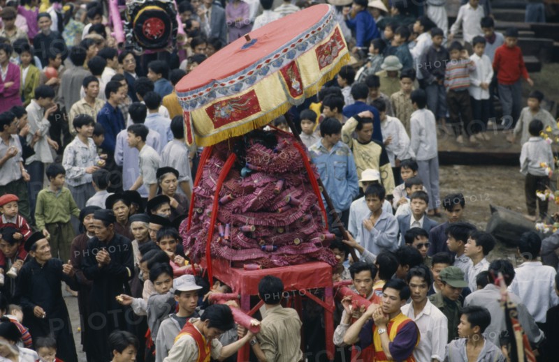 VIETNAM, North, Huge firecracker  being carried through the street at the Firecracker Festival during Tet New Year