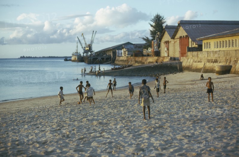 TANZANIA, Zanzibar Island, Boys playing football on the beach.