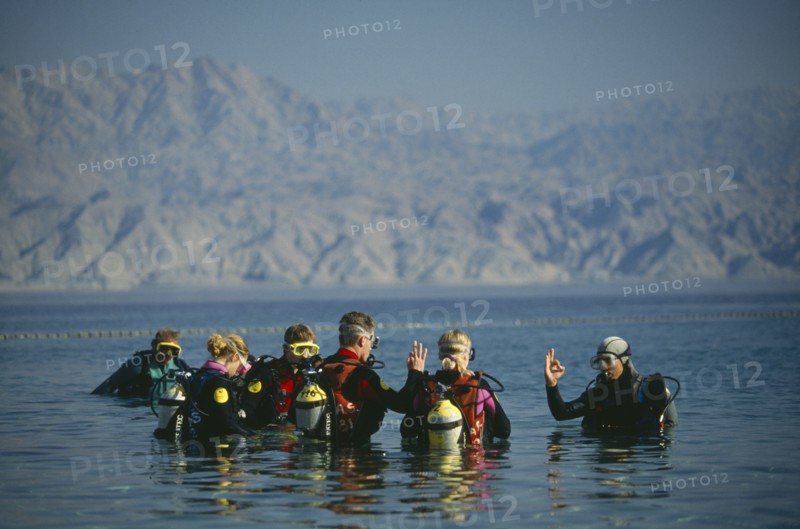 ISRAEL, Hadarom, Elat, Diving class giving the okay signal at Coral Beach underwater Nature Reserve