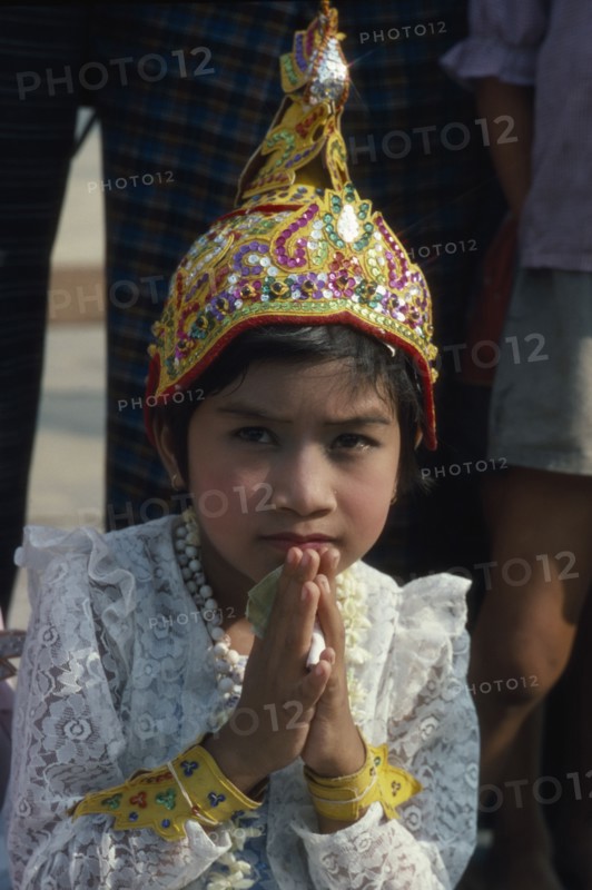 MYANMAR, Yangon, Shwedagon Pagoda.  Young girl in novice monk initiation ceremony