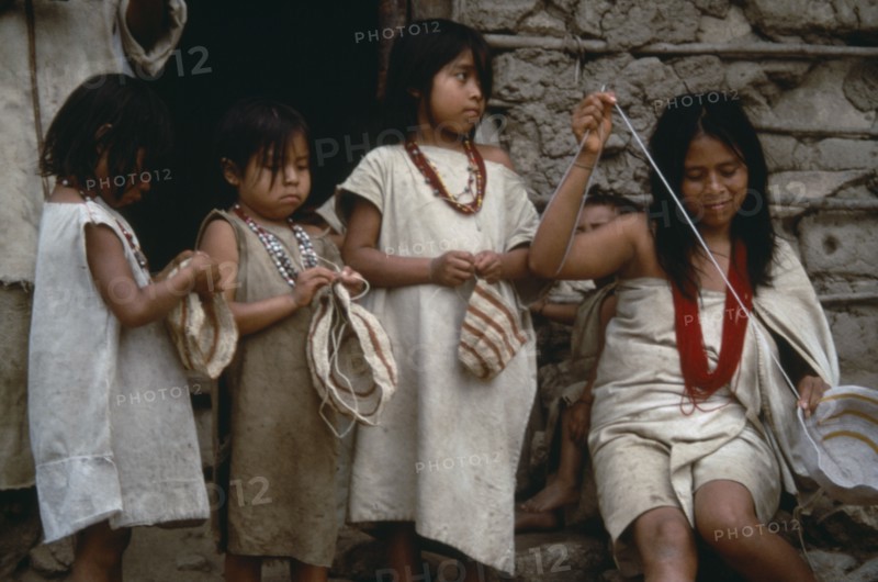 COLOMBIA, People, Kogi, Three young Kogi girls and woman bag making