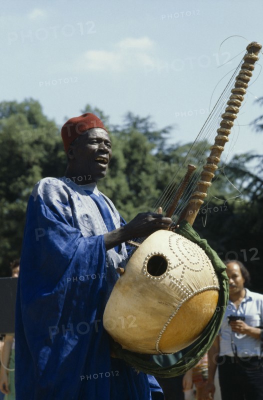 SENEGAL, Music, Manoinka musician playing the Kora which is a strung gouro instrument