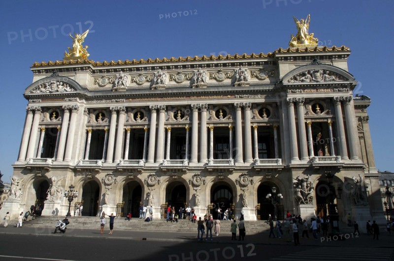FRANCE, Ile de France, Paris, The Opera Garnier columned facade with golden statues atop