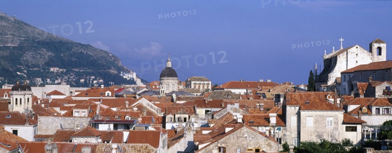 CROATIA, Dalmatia, Dubrovnik, View through a slit in the City Walls over the rooftops looking toward the Cathedral dome