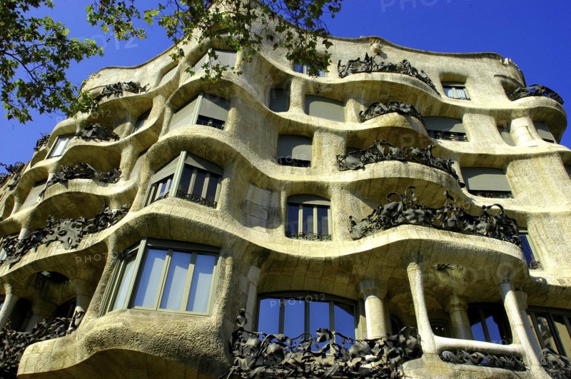 SPAIN, Catalonia, Barcelona, Angled view looking up at Gaudi apartment building Casa Mila