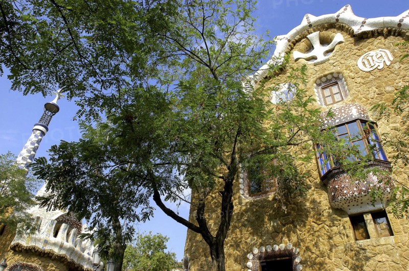 SPAIN, Catalonia, Barcelona, Gaudi architecture seen through trees in Parc Guell