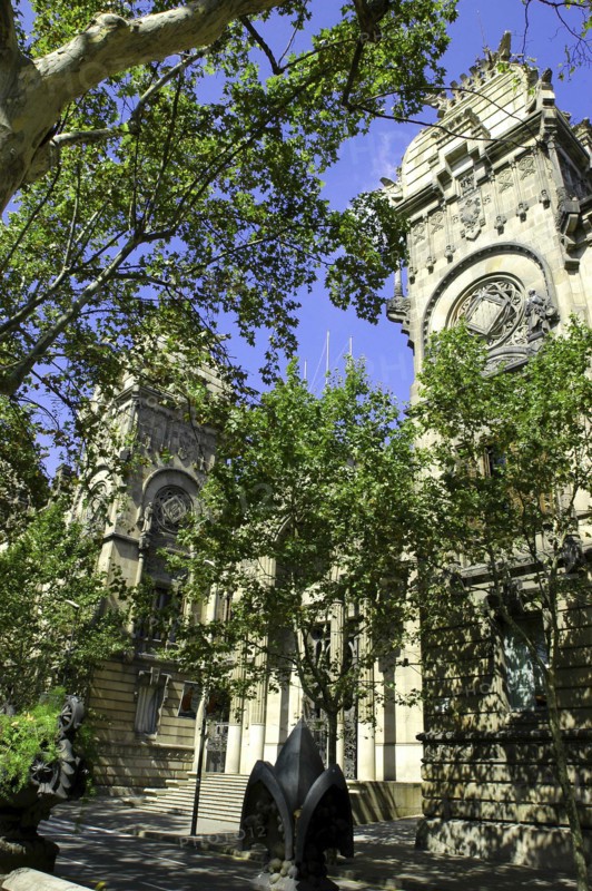 SPAIN, Catalonia, Barcelona, Angled view of the Barcelona Museum facade seen through trees