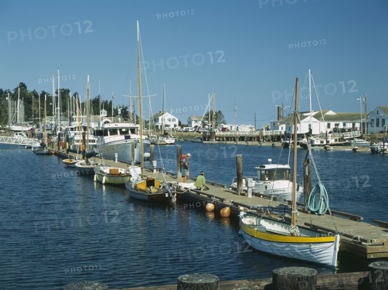 USA, Washington State, Jefferson, Port Townsend. Point Hudson Marina the Victorian seaport in the National Historic District. Boats docked either side of the pier.