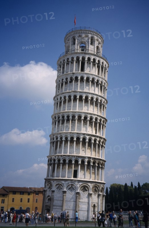 ITALY, Tuscany, Pisa, The Leaning Tower with tourists gathered at the base