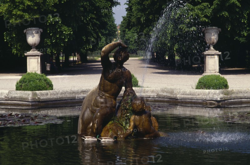 AUSTRIA, Vienna, Schonbrunn Palace Gardens.  Statue and fountain in pool.