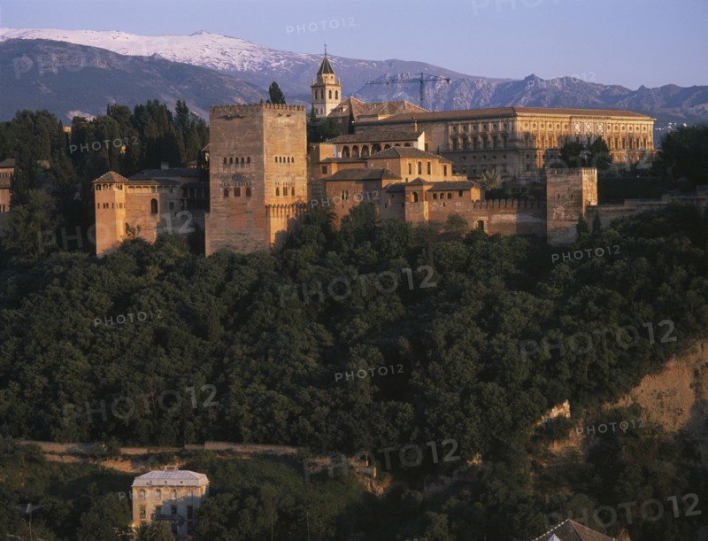 SPAIN, Andalucia, Granada, Alhambra Palace seen from Mirador San Nicolas in evening light with Palacio de Carlos V on the right