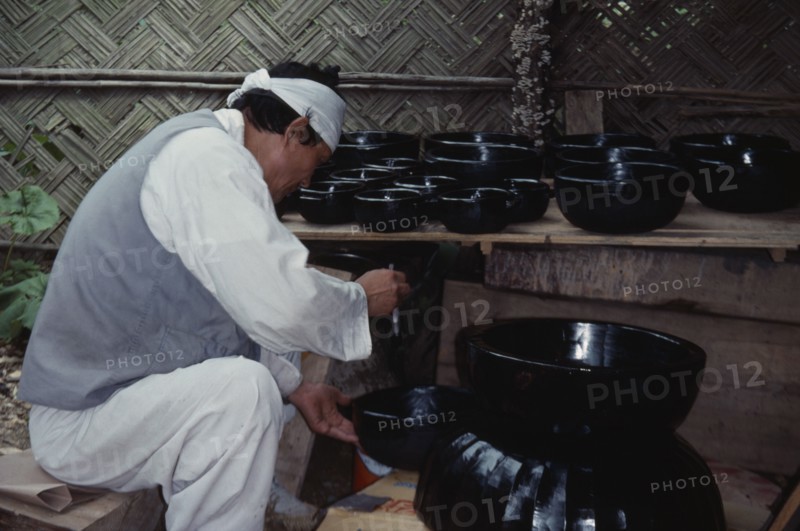 SOUTH KOREA, Crafts, Korean Folk Village.  Man lacquering wooden bowls.