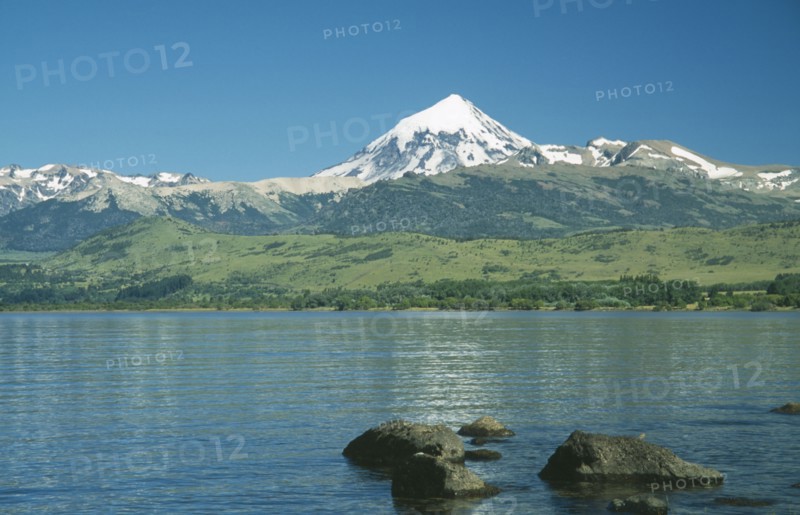 ARGENTINA, Neuquen, Lanin National Park, View over bolders of Huechulafquen Lake toward snow capped Lanin Volcano.