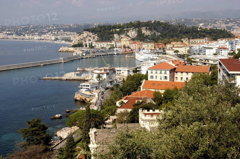 FRANCE, Cote d Azur, Nice, View over rooftops and harbour with the coastline beyond