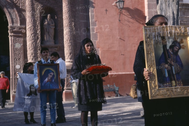 MEXICO, Guanajuato, San Miguel de Allende, Oratorio de San Felipe Neri.  Good Friday Procession with men and women carrying religious images and representation of the crown of thorns.