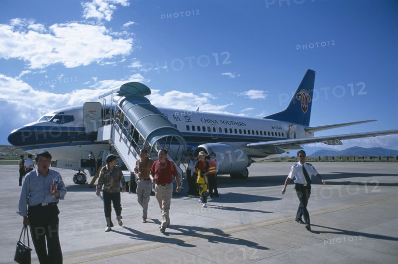CHINA, Yunnan , Dali, Domestic aircraft on runway with passengers disembarking.