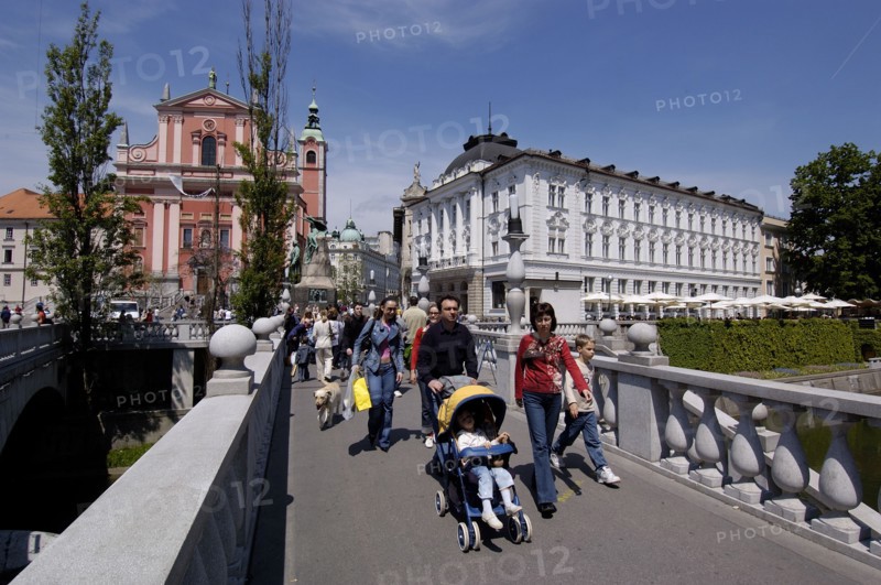 SLOVENIA, Ljubljana, View along the Triple Bridge in the city centre with pedestrians crossing