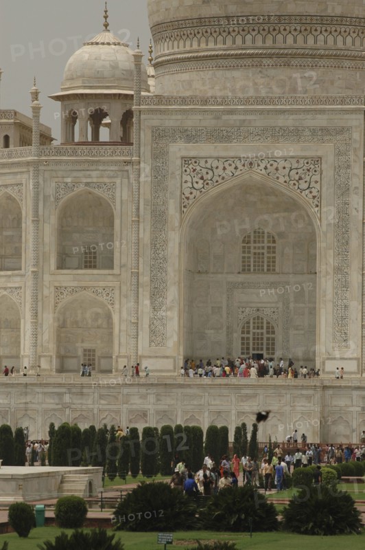 INDIA, Uttar Pradesh, Agra, "A section of the white marble Taj Mahal exterior section including the entrance, garden, and dome"